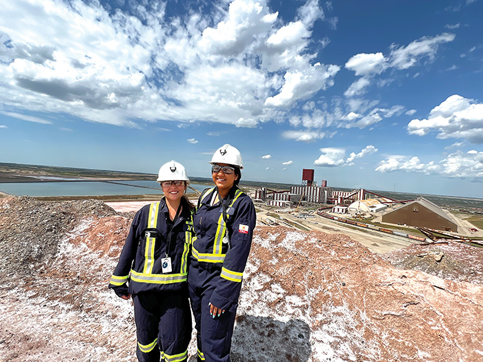 Sunnette Kamffer and Sierra D’Souza Butts at the top of the salt pile at the Rocanville site.<br />